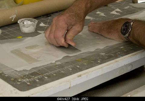 PLace another layer of Vinyl on the saturated glass cloth and squeegee out the resin excess.
